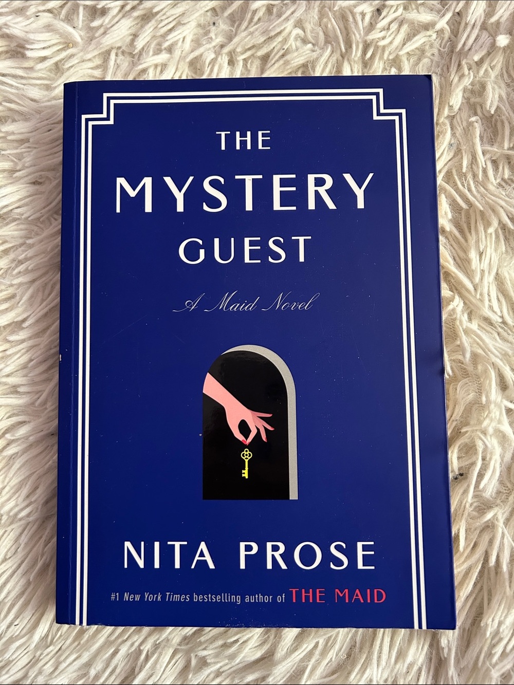 The Mystery Guest by Nita Prose - Blue paperback Novel, like new